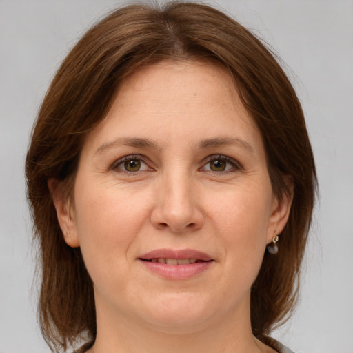 Joyful white adult female with medium  brown hair and grey eyes