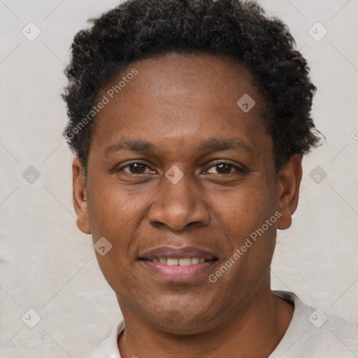 Joyful black adult male with short  brown hair and brown eyes