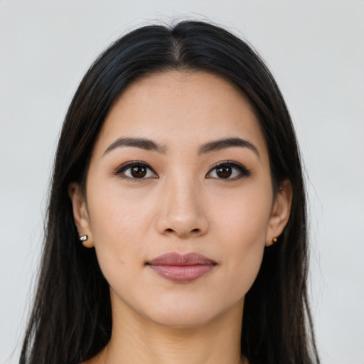 Joyful latino young-adult female with long  brown hair and brown eyes