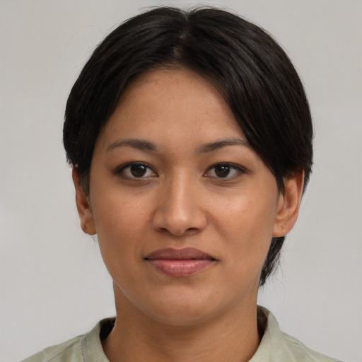 Joyful asian young-adult female with short  black hair and brown eyes