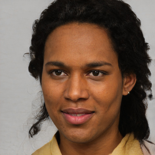 Joyful black young-adult female with short  brown hair and brown eyes