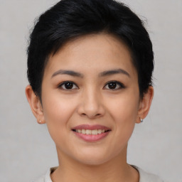 Joyful asian young-adult female with short  black hair and brown eyes