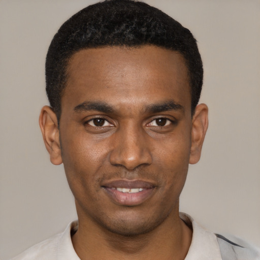 Joyful black young-adult male with short  black hair and brown eyes