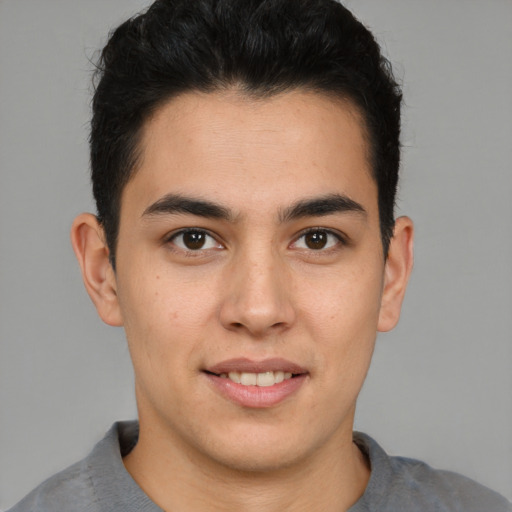 Joyful latino young-adult male with short  brown hair and brown eyes