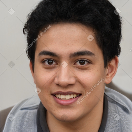 Joyful latino young-adult male with short  brown hair and brown eyes