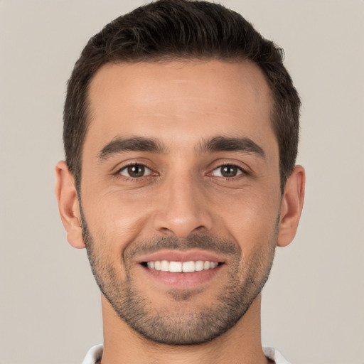 Joyful white young-adult male with short  brown hair and brown eyes