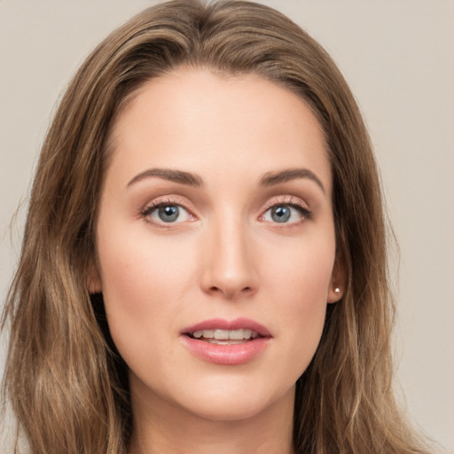 Joyful white young-adult female with long  brown hair and green eyes