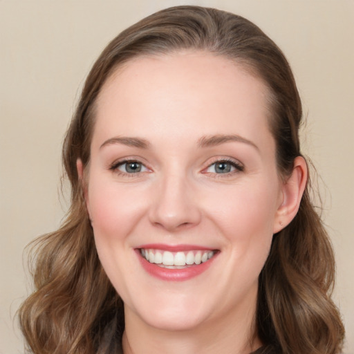 Joyful white young-adult female with medium  brown hair and blue eyes