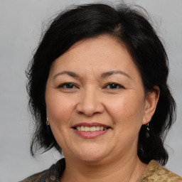 Joyful white adult female with medium  brown hair and brown eyes