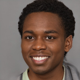 Joyful black young-adult male with short  brown hair and brown eyes