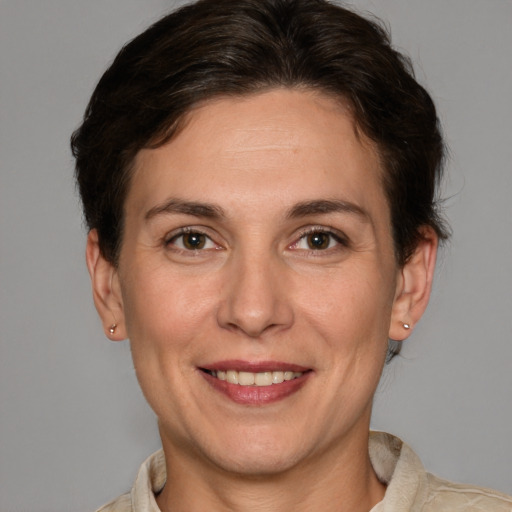 Joyful white adult female with short  brown hair and grey eyes