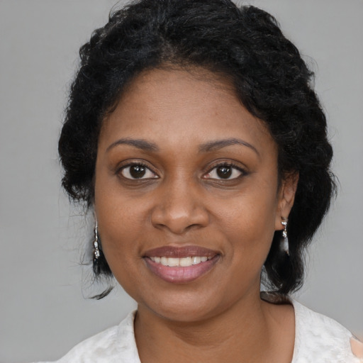 Joyful black young-adult female with medium  black hair and brown eyes