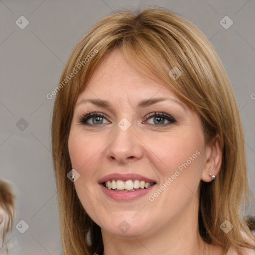 Joyful white young-adult female with medium  brown hair and blue eyes