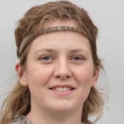 Joyful white young-adult female with medium  brown hair and blue eyes