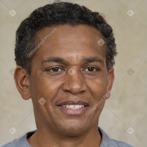 Joyful black adult male with short  brown hair and brown eyes