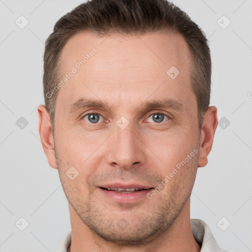 Joyful white adult male with short  brown hair and grey eyes