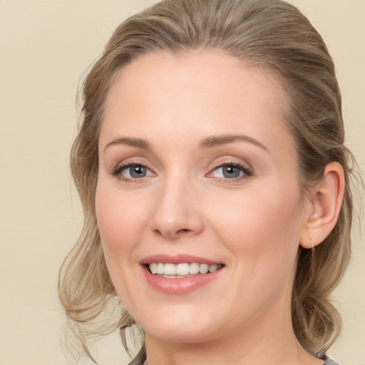 Joyful white young-adult female with medium  brown hair and grey eyes