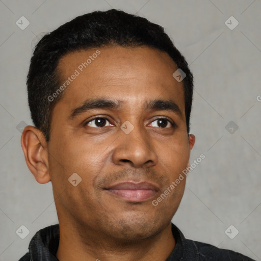 Joyful black young-adult male with short  black hair and brown eyes