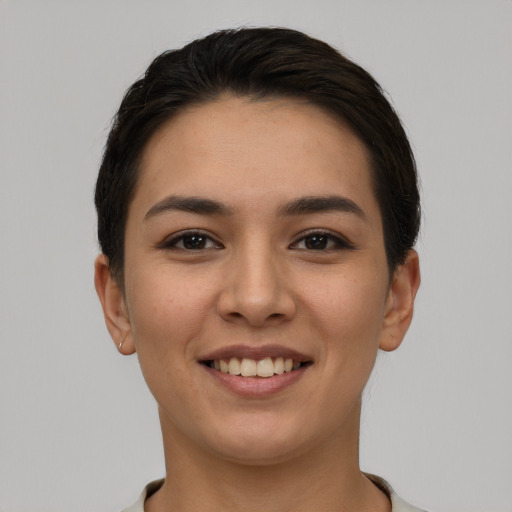 Joyful white young-adult female with short  black hair and brown eyes