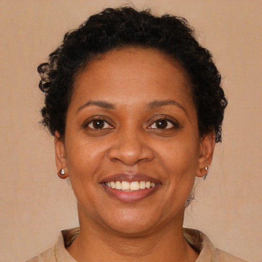 Joyful black young-adult female with short  brown hair and brown eyes