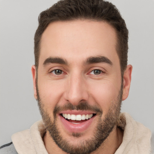 Joyful white young-adult male with short  brown hair and brown eyes