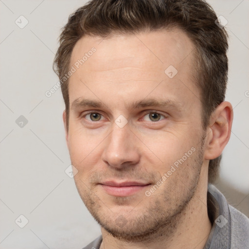 Joyful white adult male with short  brown hair and brown eyes