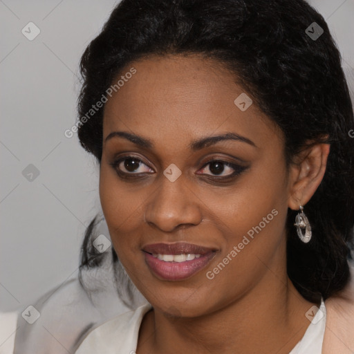 Joyful black young-adult female with long  black hair and brown eyes