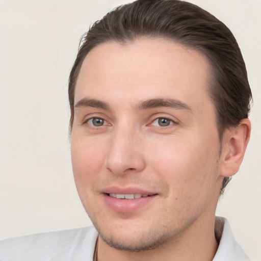 Joyful white young-adult male with short  brown hair and brown eyes