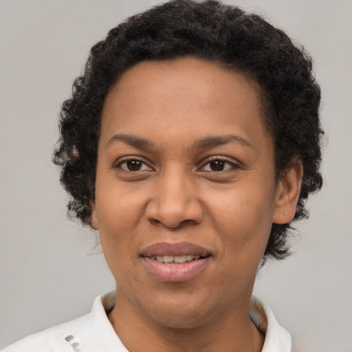 Joyful black adult female with short  brown hair and brown eyes