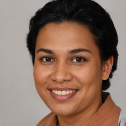 Joyful latino young-adult female with short  brown hair and brown eyes