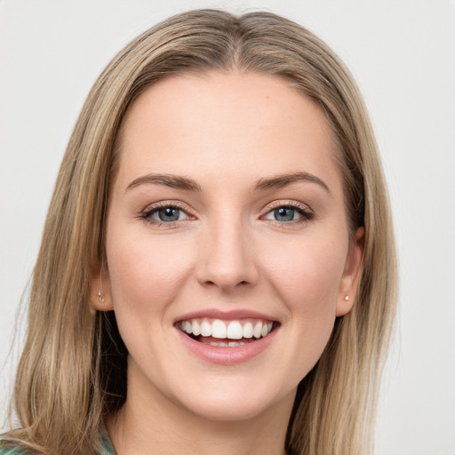 Joyful white young-adult female with long  brown hair and green eyes