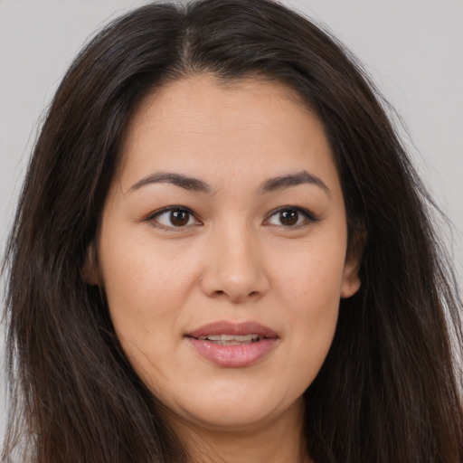Joyful white young-adult female with long  brown hair and brown eyes
