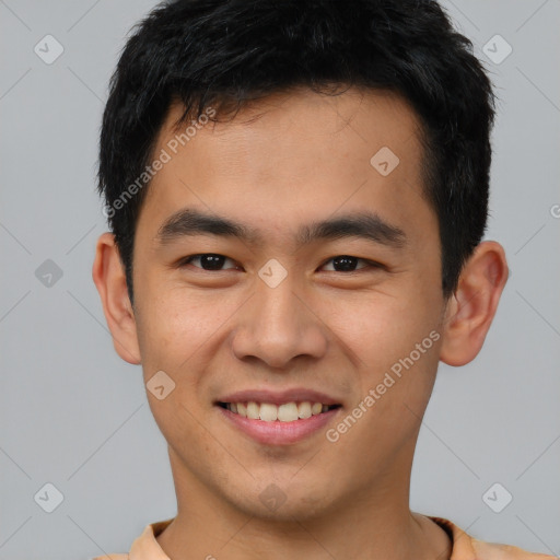 Joyful asian young-adult male with short  brown hair and brown eyes