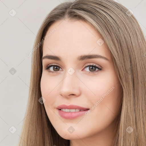 Joyful white young-adult female with long  brown hair and brown eyes