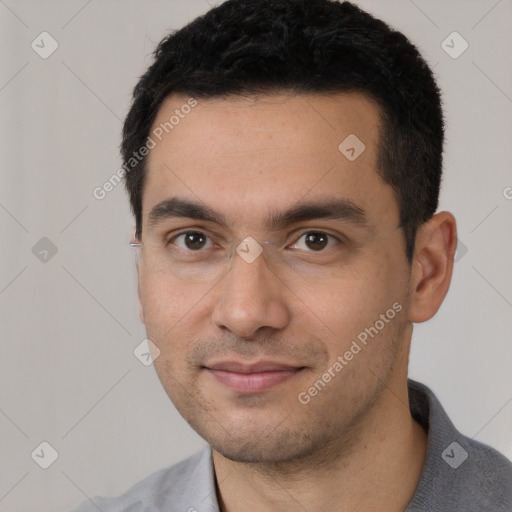 Joyful white young-adult male with short  black hair and brown eyes