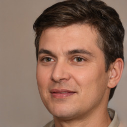Joyful white adult male with short  brown hair and brown eyes