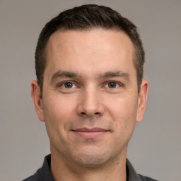 Joyful white adult male with short  brown hair and grey eyes