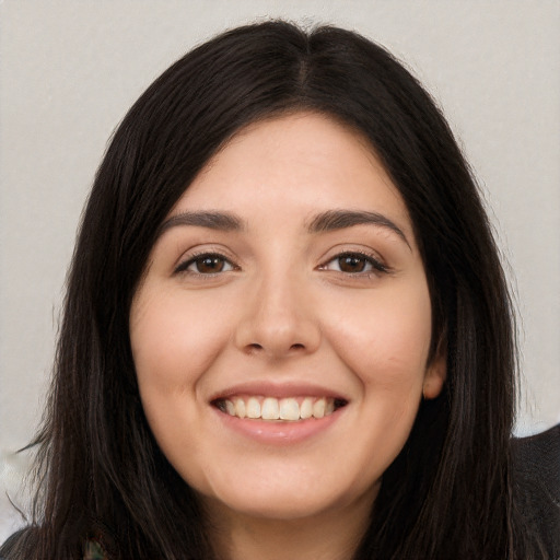 Joyful white young-adult female with long  black hair and brown eyes