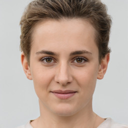 Joyful white young-adult female with short  brown hair and grey eyes