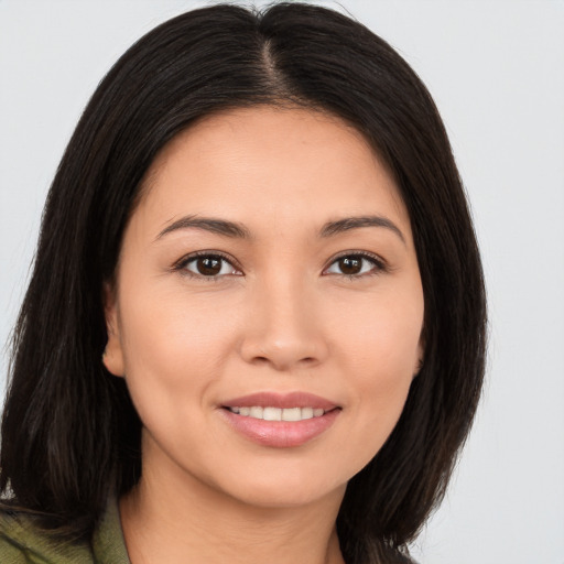 Joyful white young-adult female with long  brown hair and brown eyes