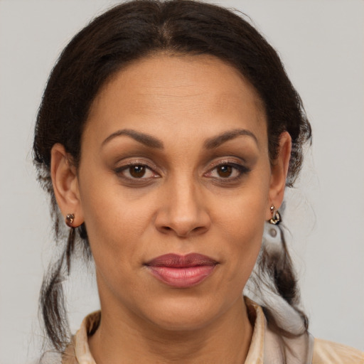 Joyful latino adult female with medium  brown hair and brown eyes