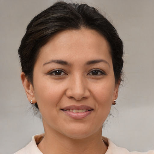 Joyful asian young-adult female with short  brown hair and brown eyes