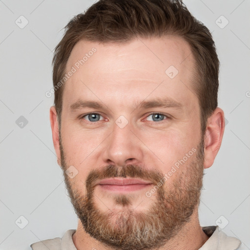 Joyful white young-adult male with short  brown hair and grey eyes