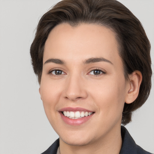 Joyful white young-adult female with medium  brown hair and brown eyes