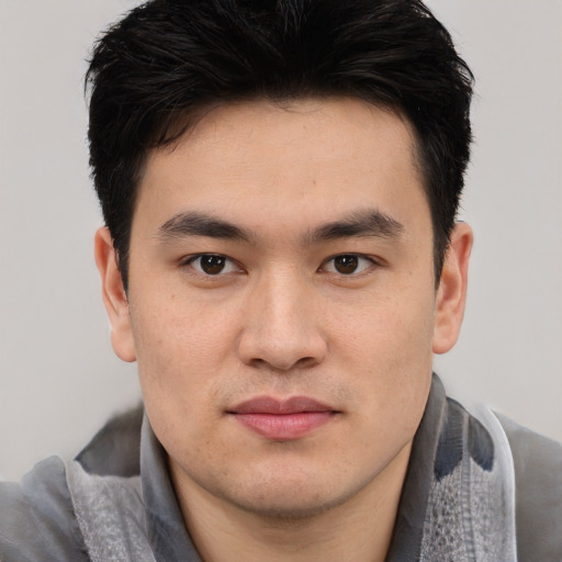 Joyful asian young-adult male with short  brown hair and brown eyes