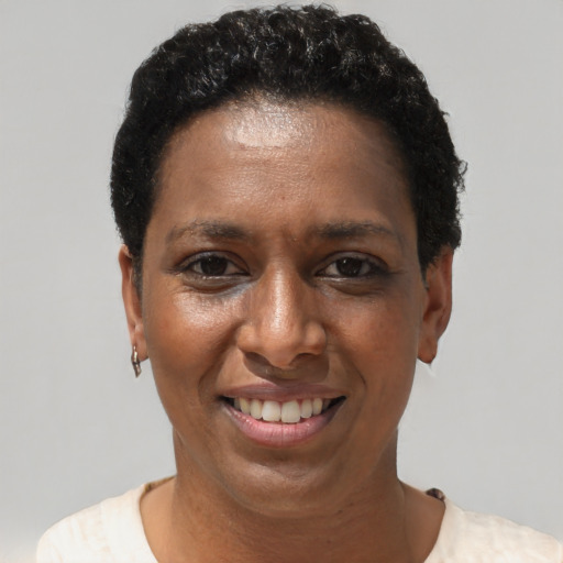 Joyful latino adult female with short  black hair and brown eyes