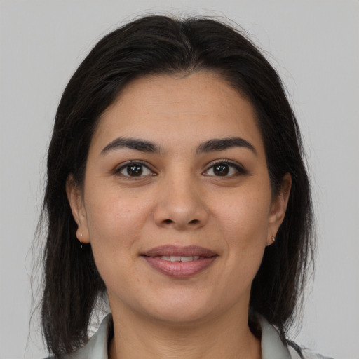 Joyful latino young-adult female with medium  brown hair and brown eyes