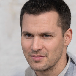 Joyful white adult male with short  brown hair and brown eyes