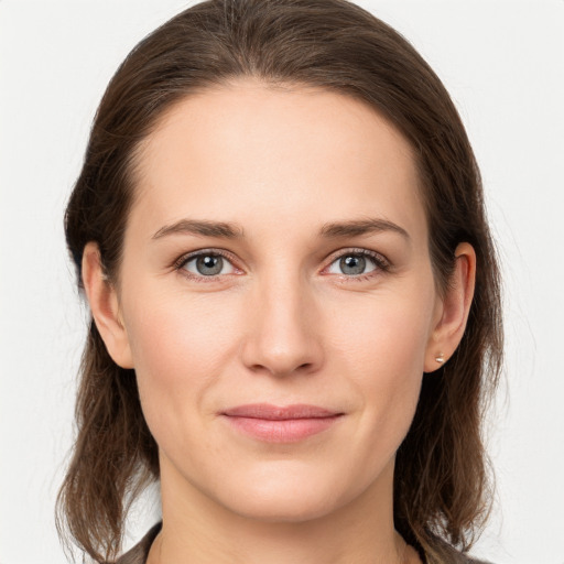 Joyful white young-adult female with medium  brown hair and grey eyes