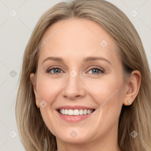 Joyful white young-adult female with long  brown hair and grey eyes